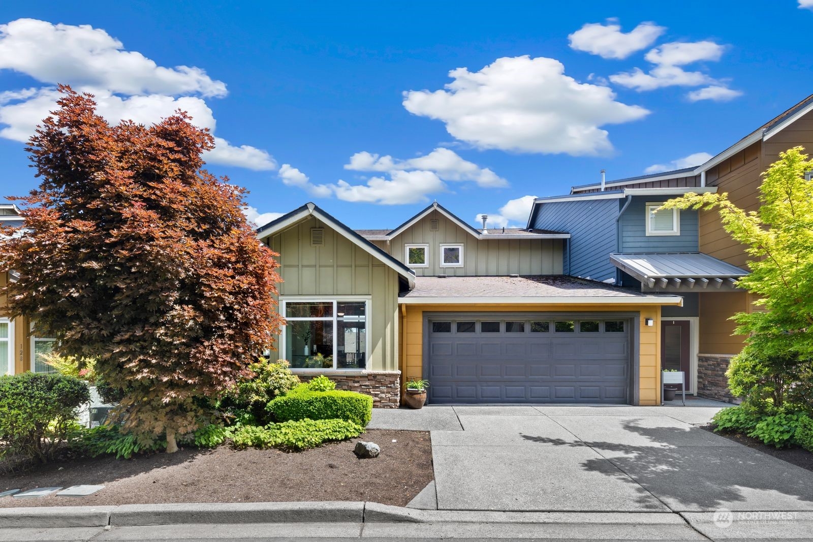 a front view of a house with a yard and garage