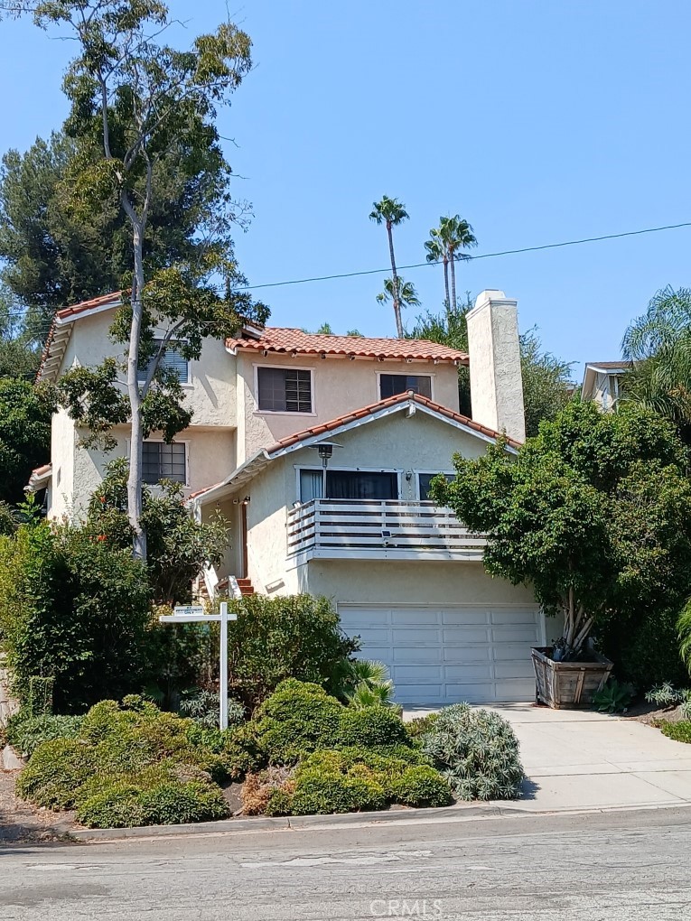 a view of a house with a yard and plants