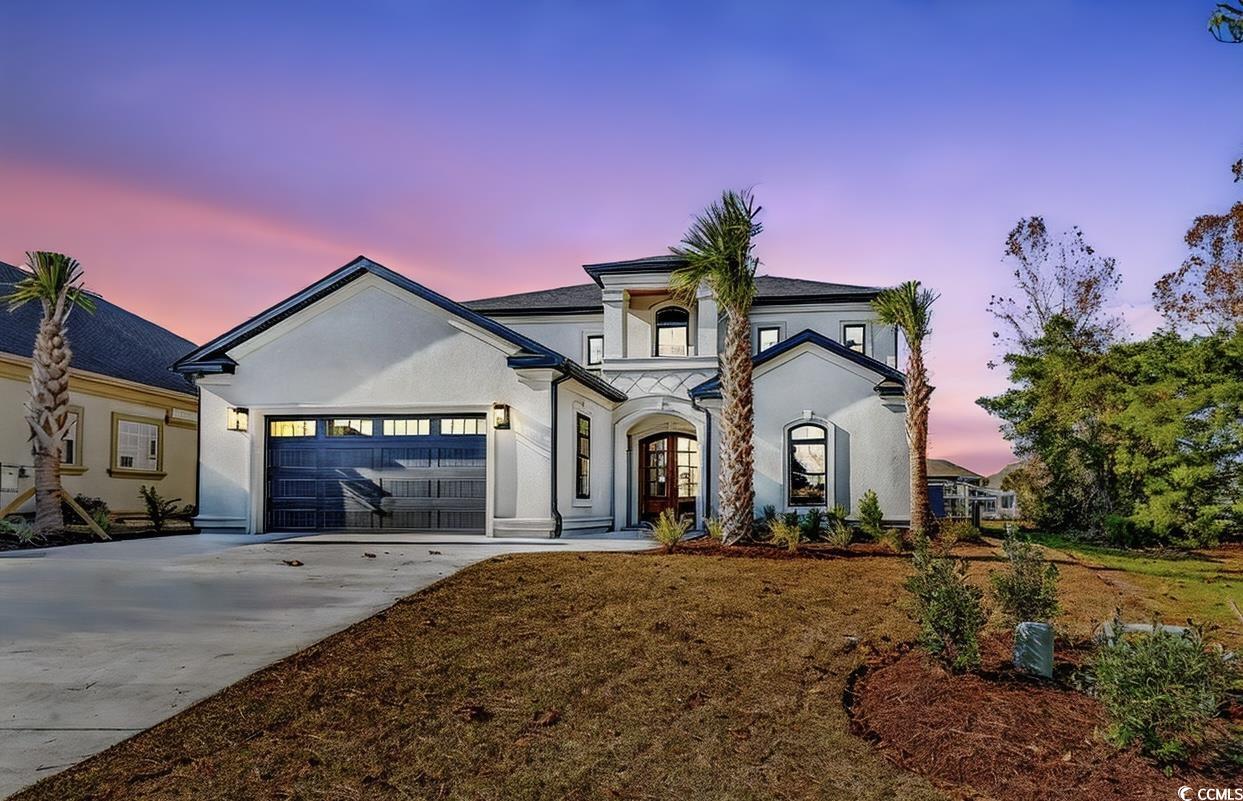 View of front of property featuring a garage and f