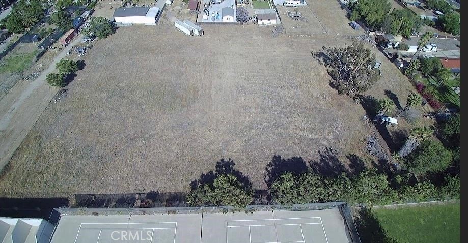 an aerial view of a house with a yard and a large tree