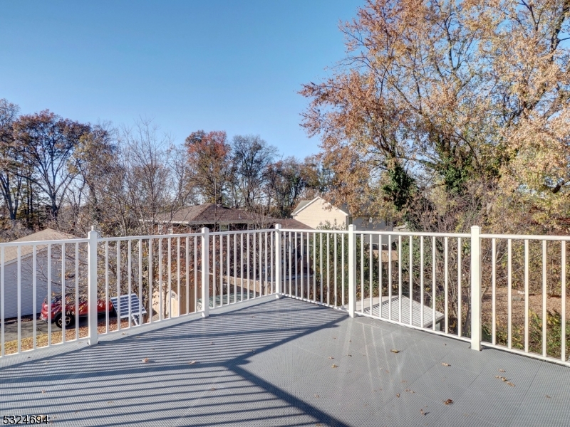 a balcony with wooden floor and fence