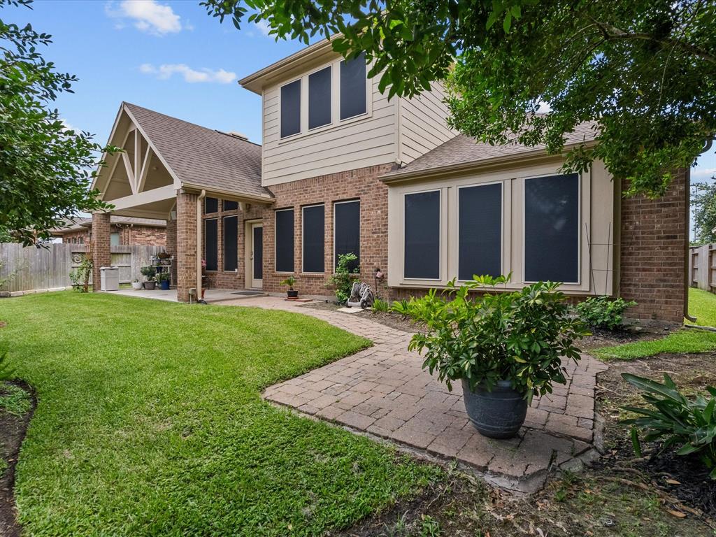 a front view of a house with garden and plants