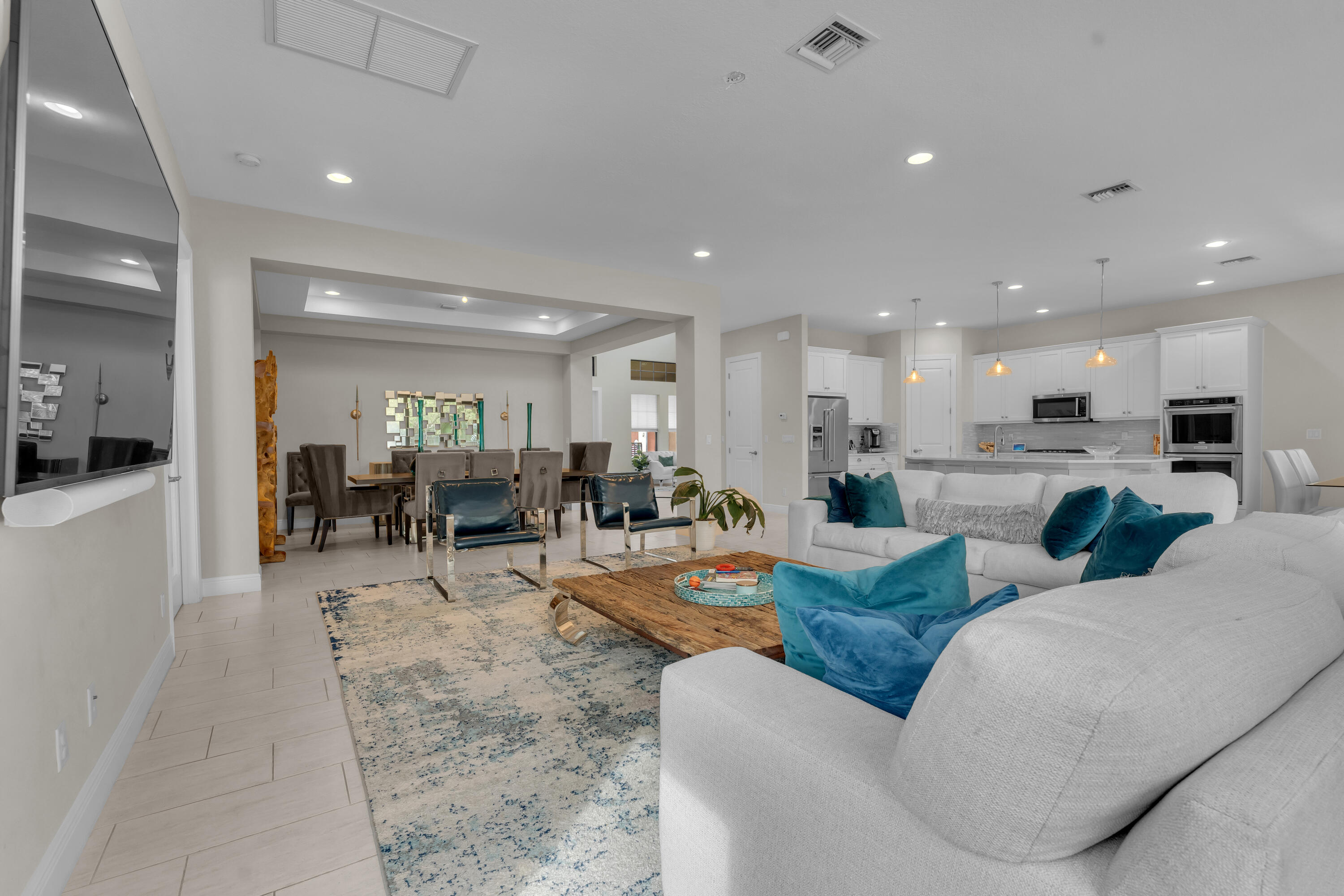 a living room with furniture a table and chairs in it