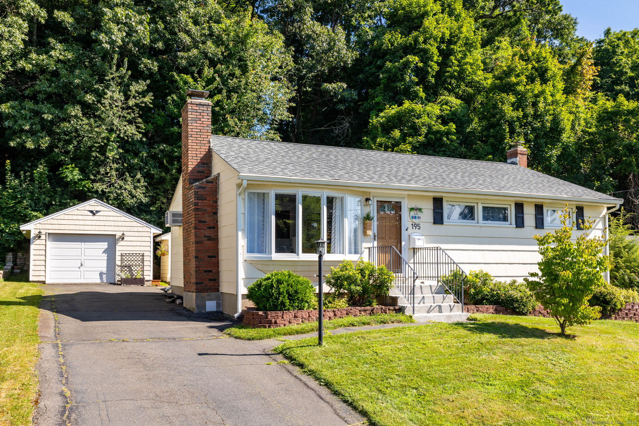 a front view of a house with a yard and porch