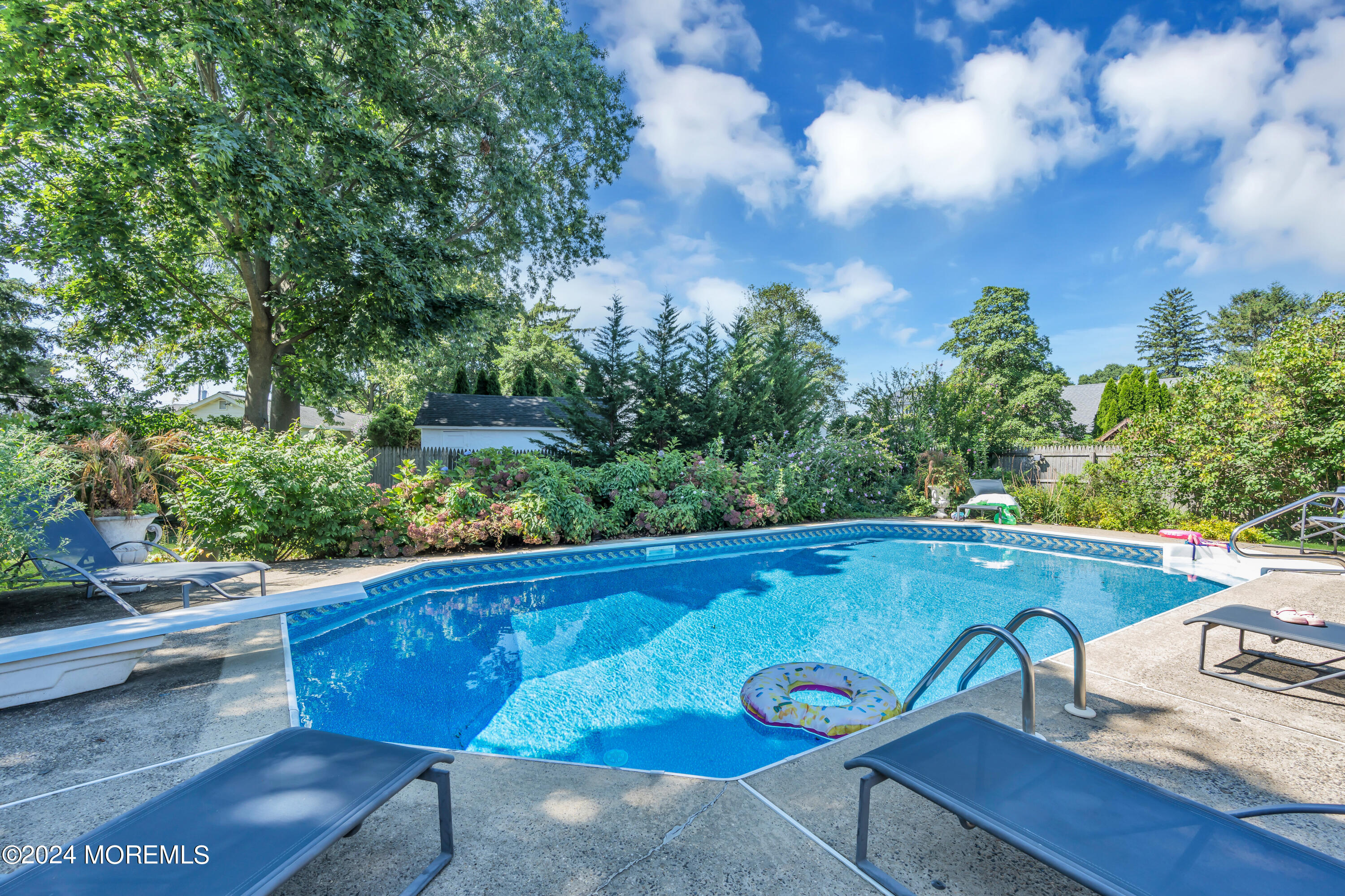 a view of a swimming pool with chairs