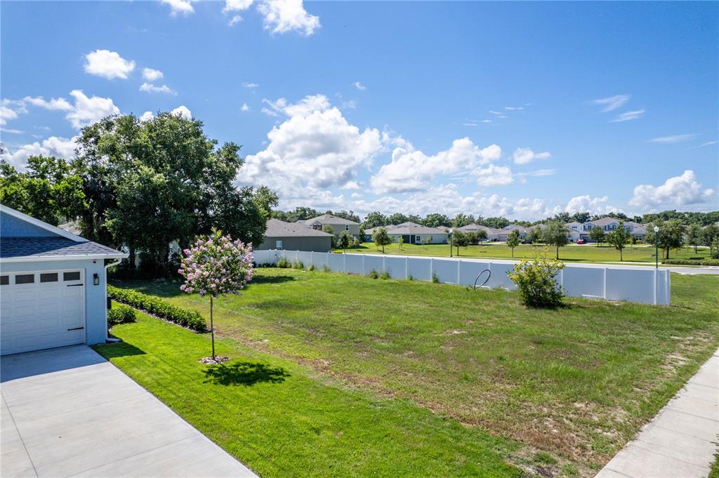 a view of a house with a yard and a fountain