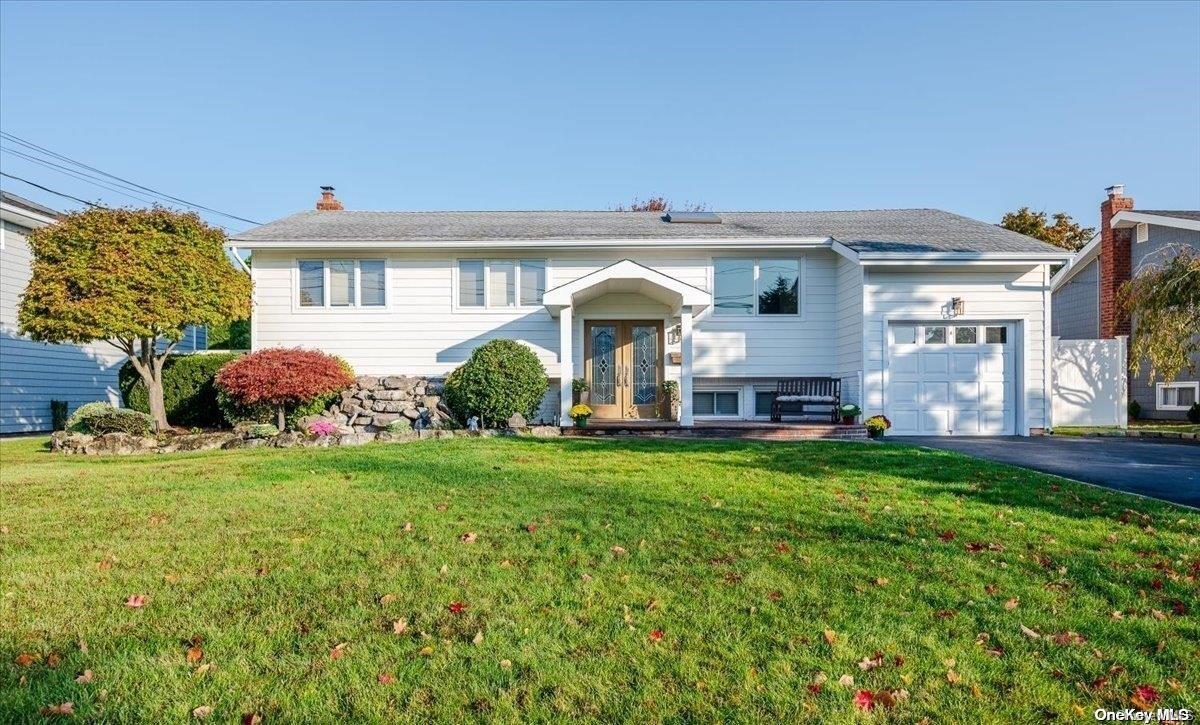 a front view of house with yard and outdoor seating