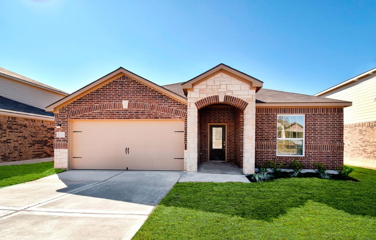 a front view of a house with a yard and garage