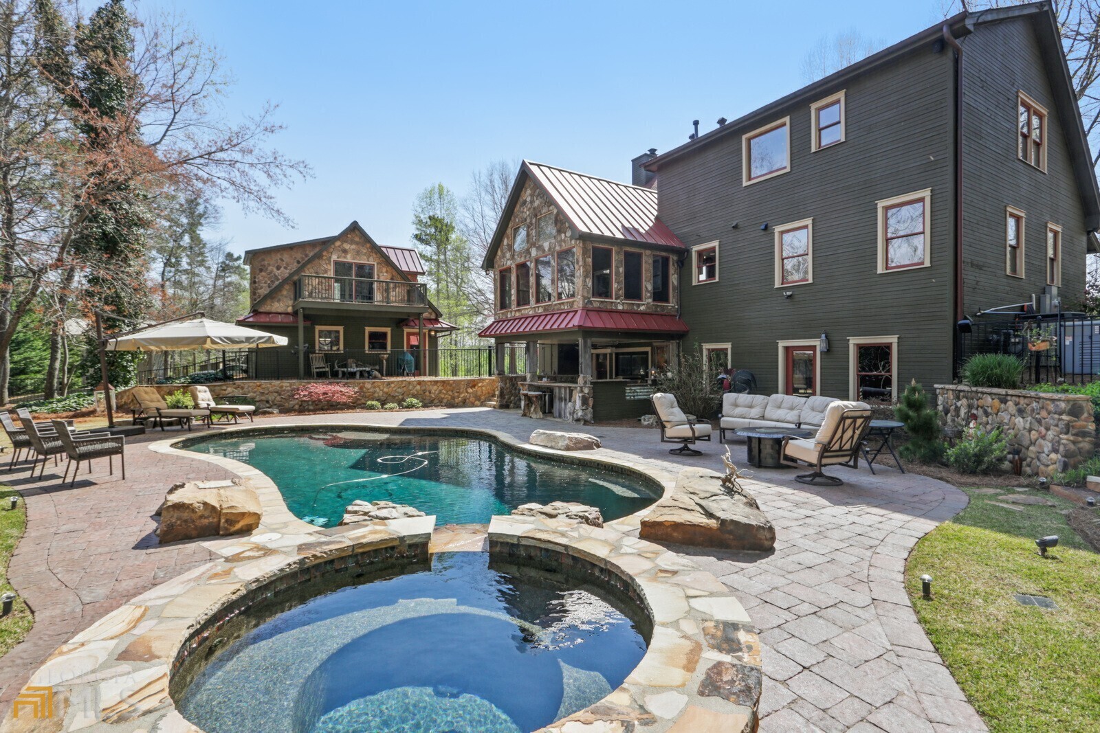 a view of a house with swimming pool and sitting area