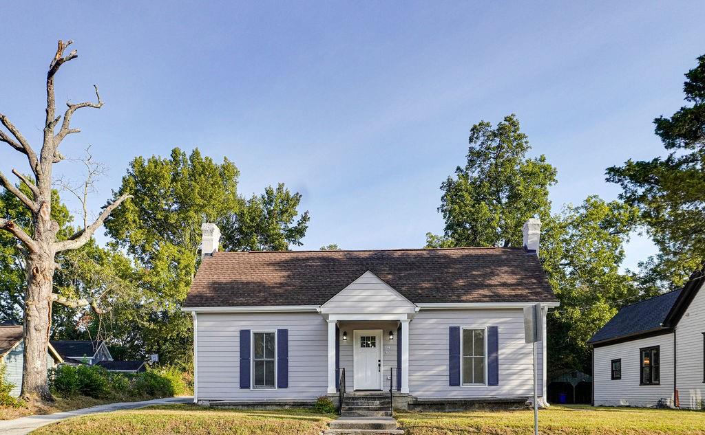 a front view of a house with a garden