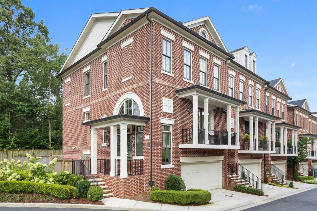 a front view of a residential apartment building with a yard