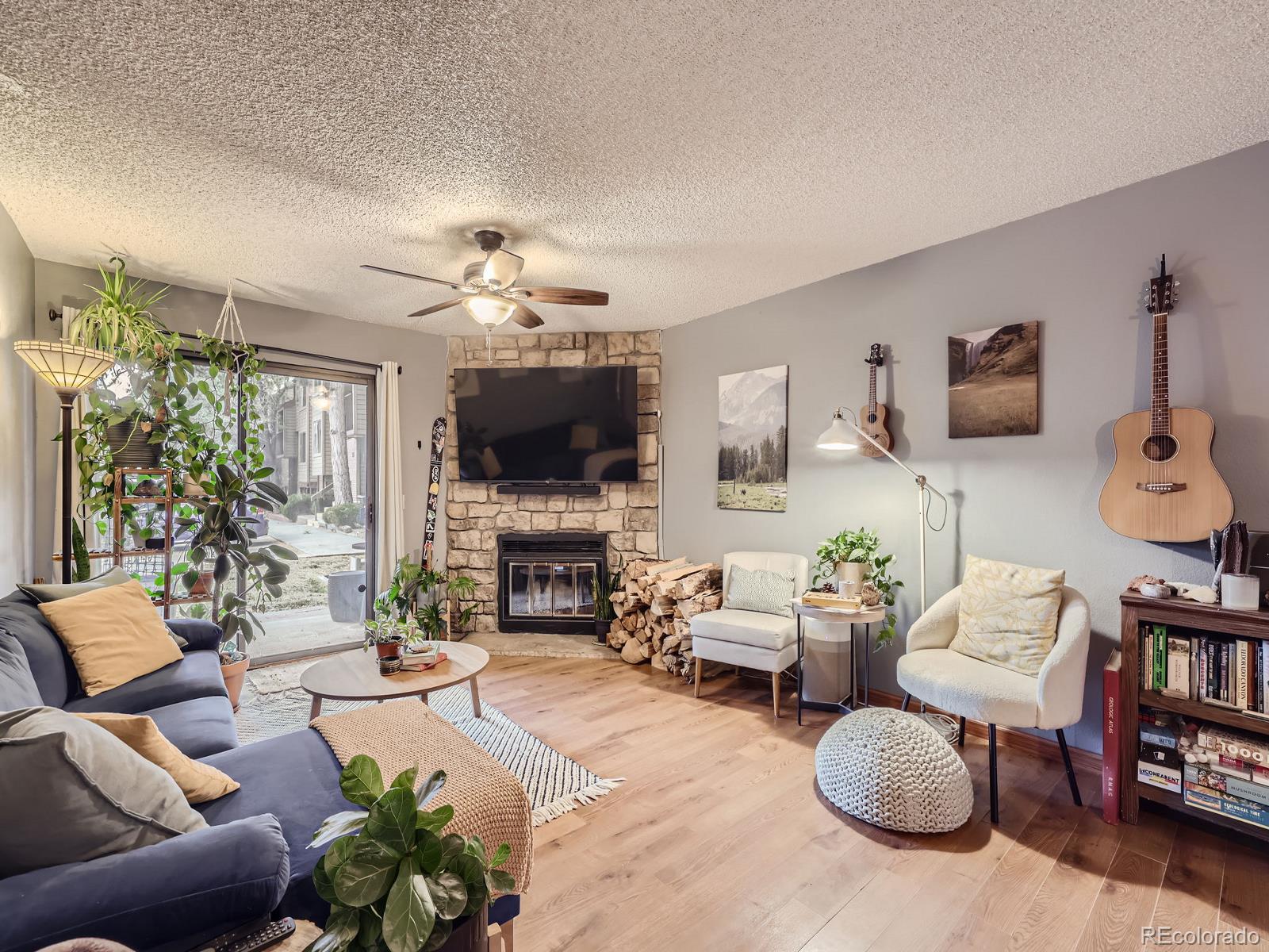 a living room with furniture a fireplace and a flat screen tv