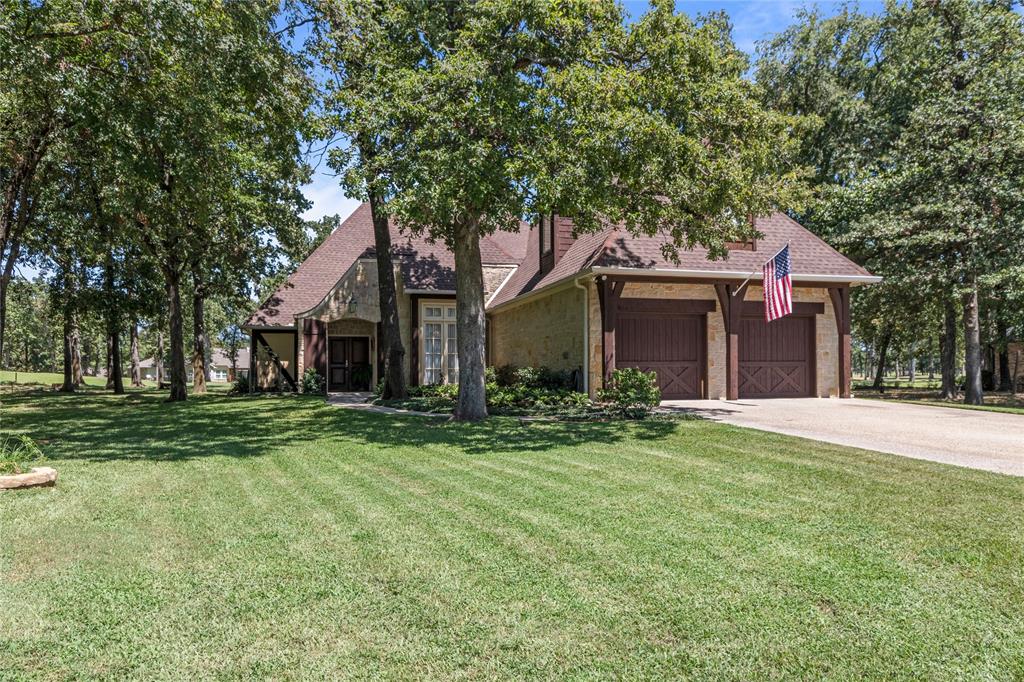 front view of a brick house with a yard