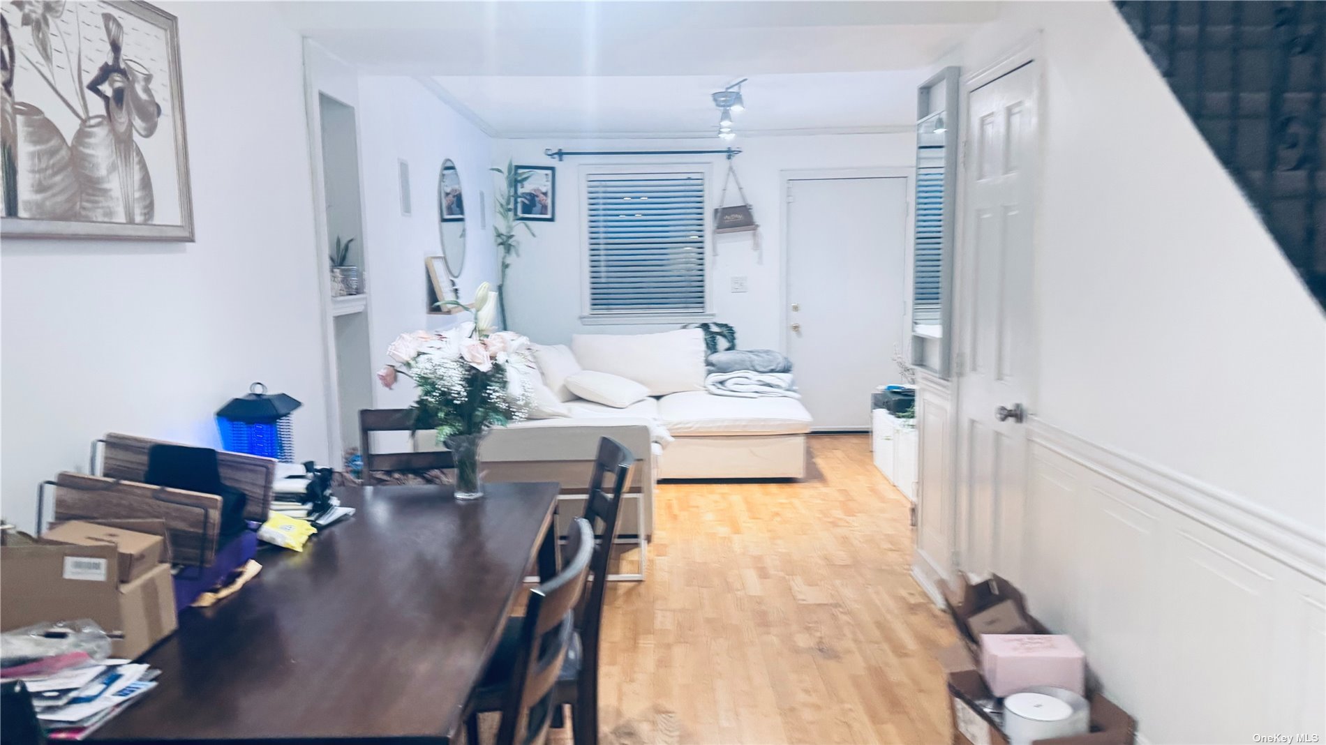 a dining room with furniture and wooden floor