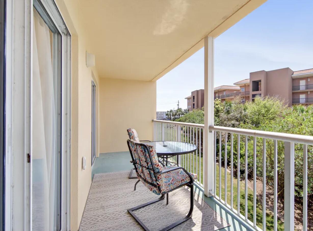 a view of a balcony with furniture