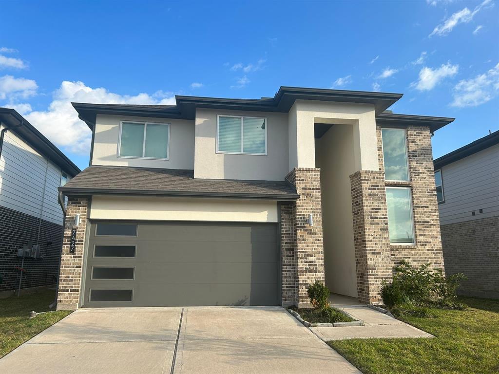 a front view of a house with a garage