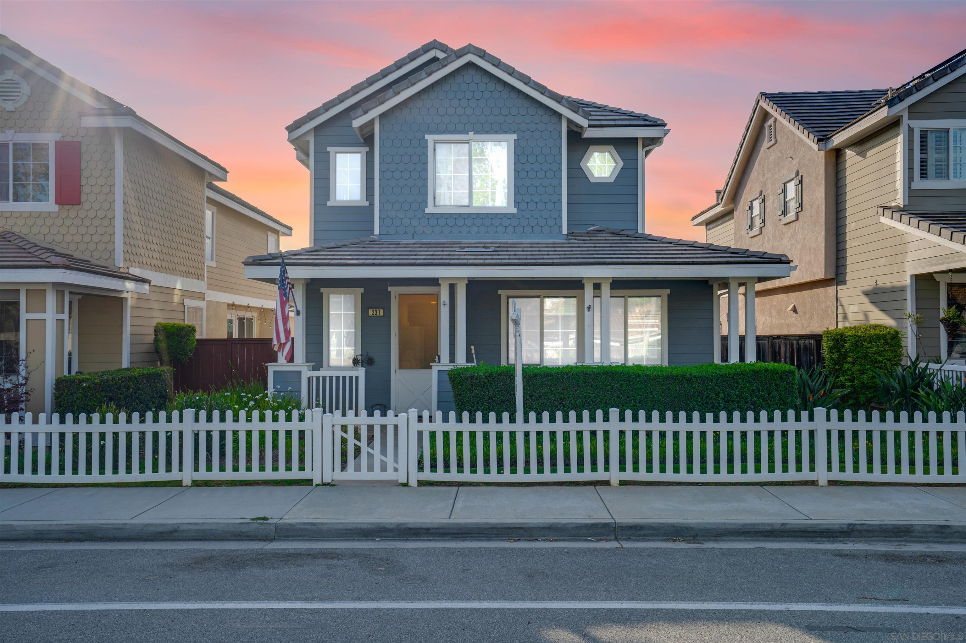 a front view of a house with a fence