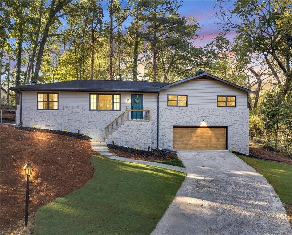 a front view of a house with a yard and garage