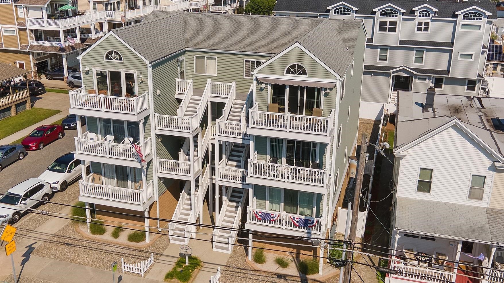 a front view of a residential apartment building with a yard