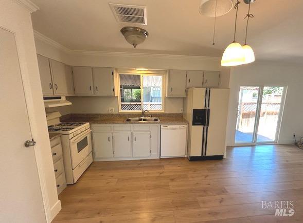 a kitchen with white cabinets and white appliances