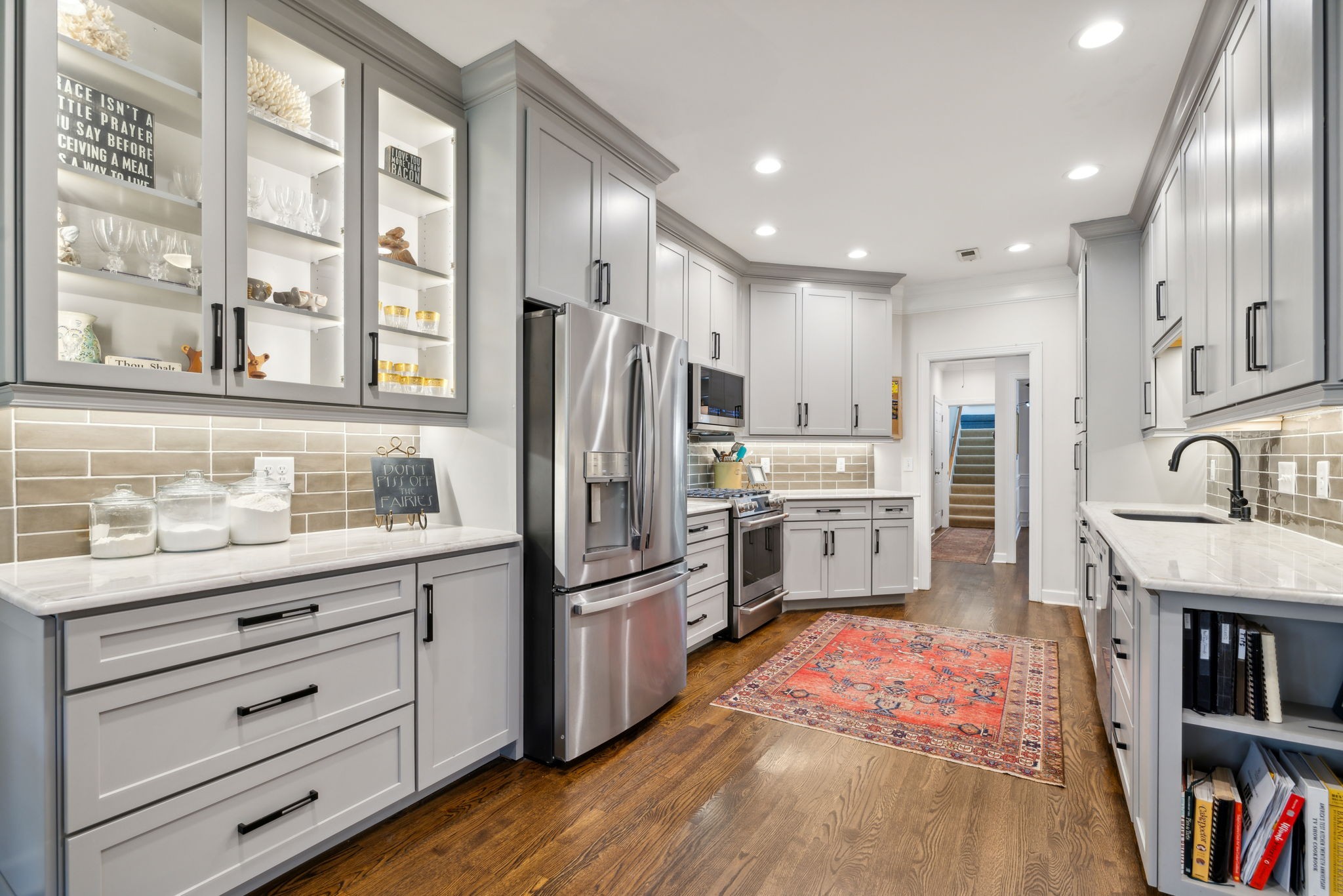 a kitchen with stainless steel appliances a refrigerator sink and cabinets