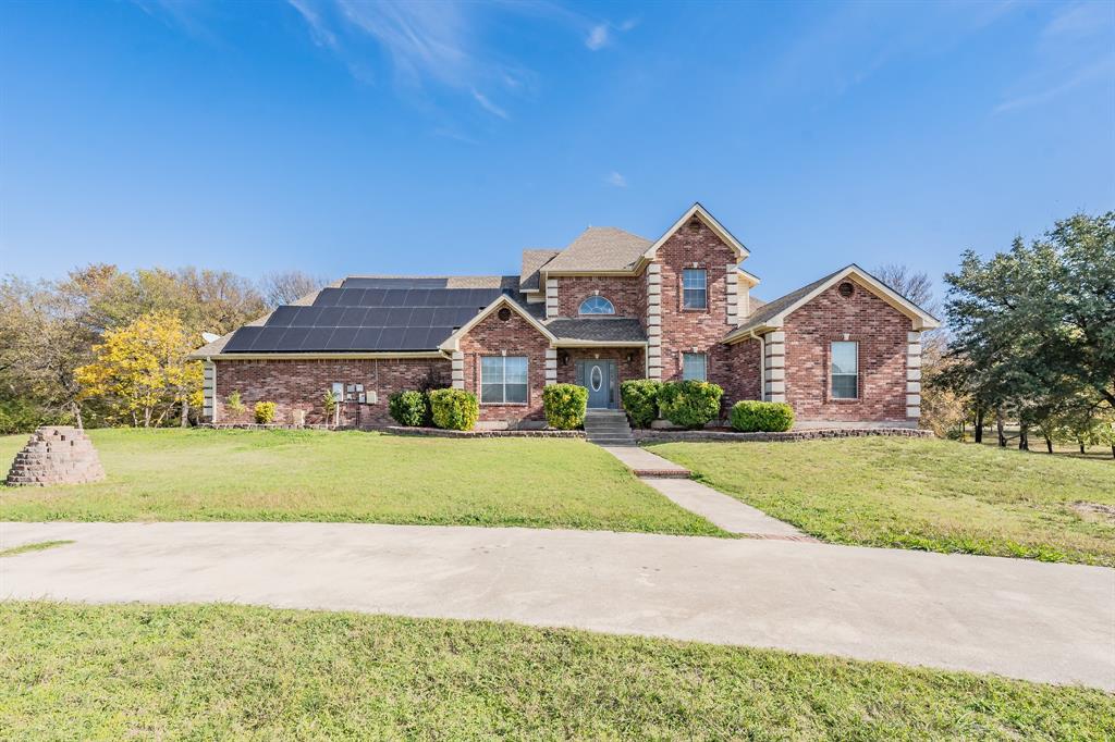 a front view of house with yard and green space