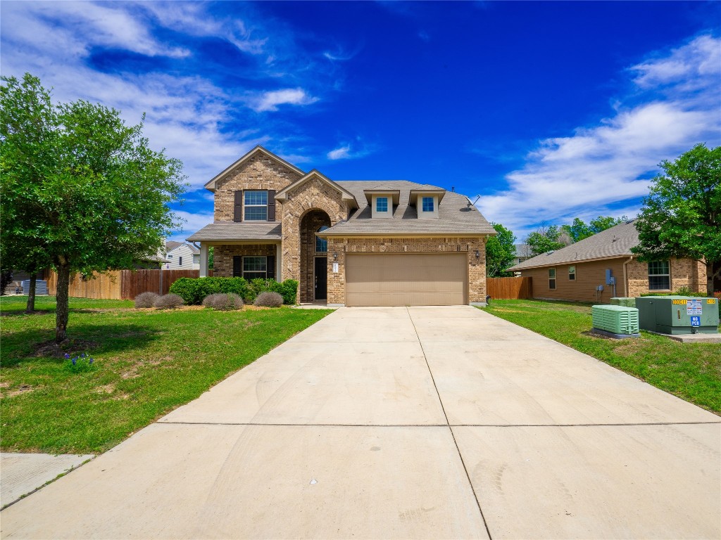 a front view of a house with a yard