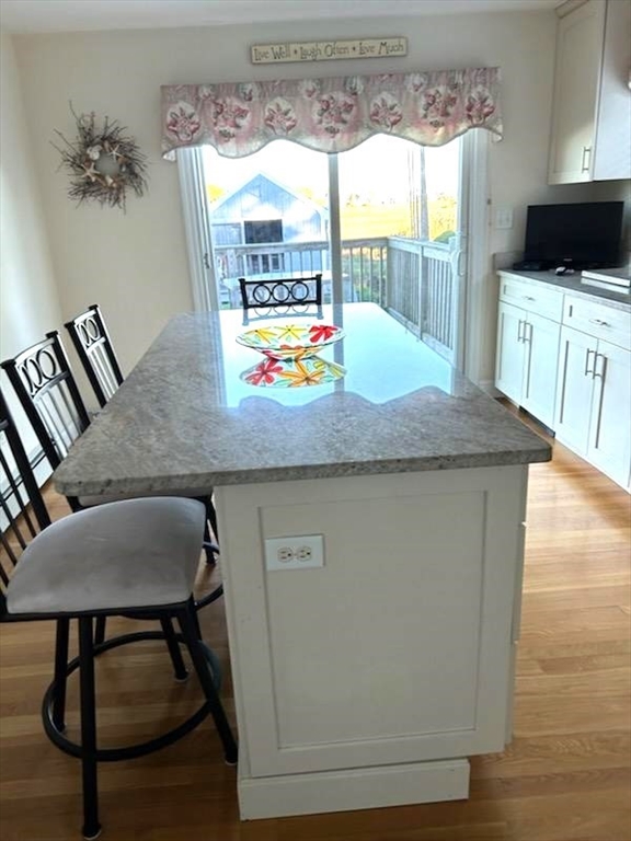 a kitchen with a table chairs and a wooden floor