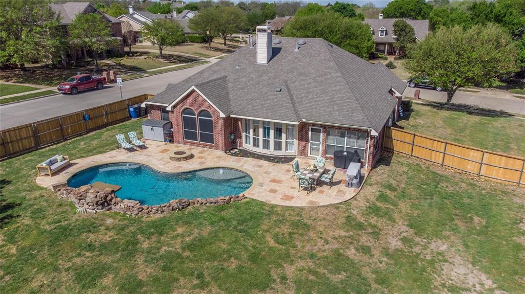 an aerial view of a house with outdoor space