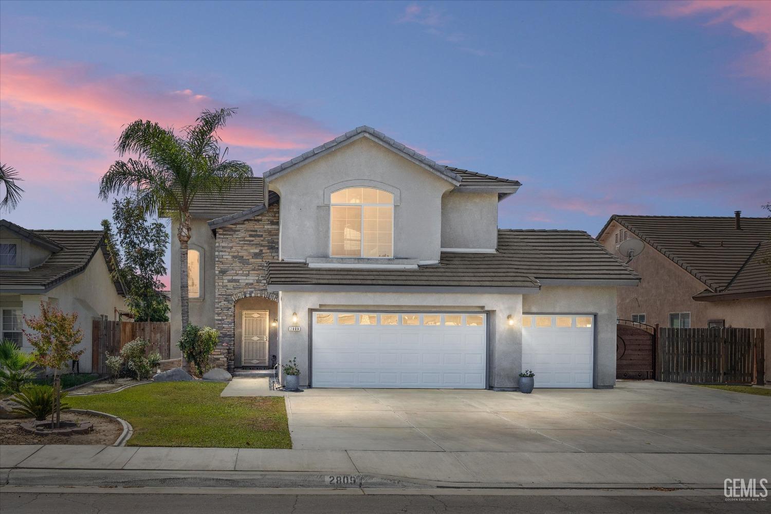 a view of a house with a yard and garage