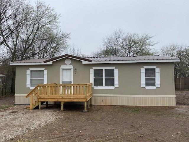 a view of a house with a yard and fence