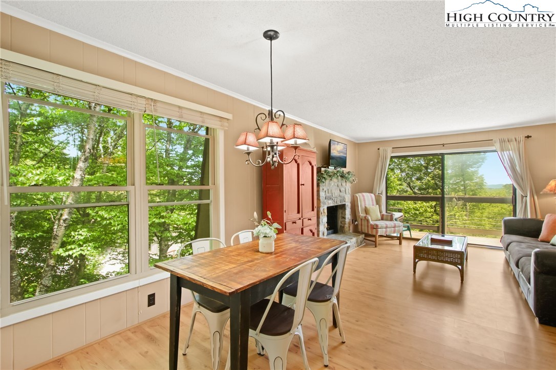 a view of a dining room with furniture large windows and wooden floor