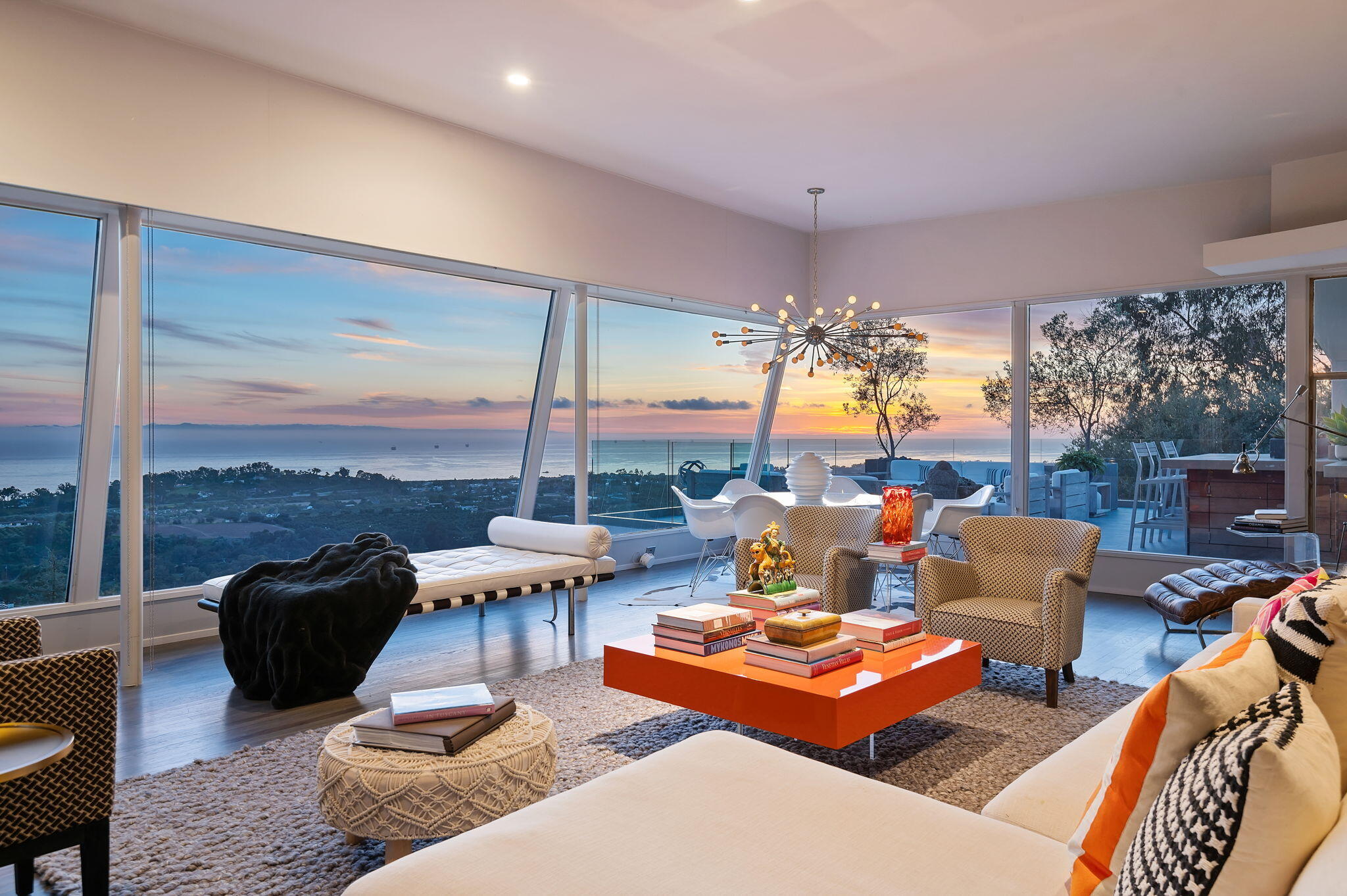 a living room with furniture and a floor to ceiling window