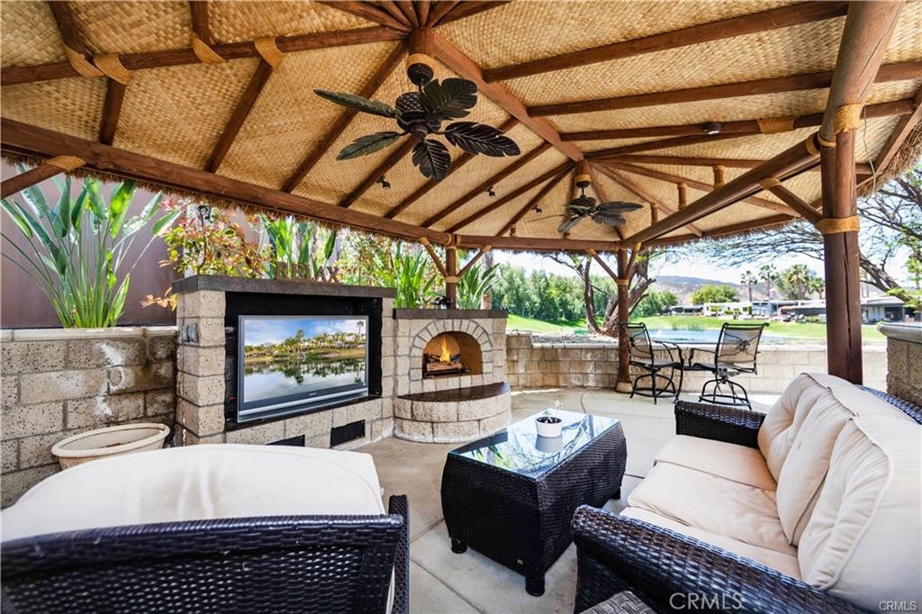 a outdoor living space with furniture and a fireplace