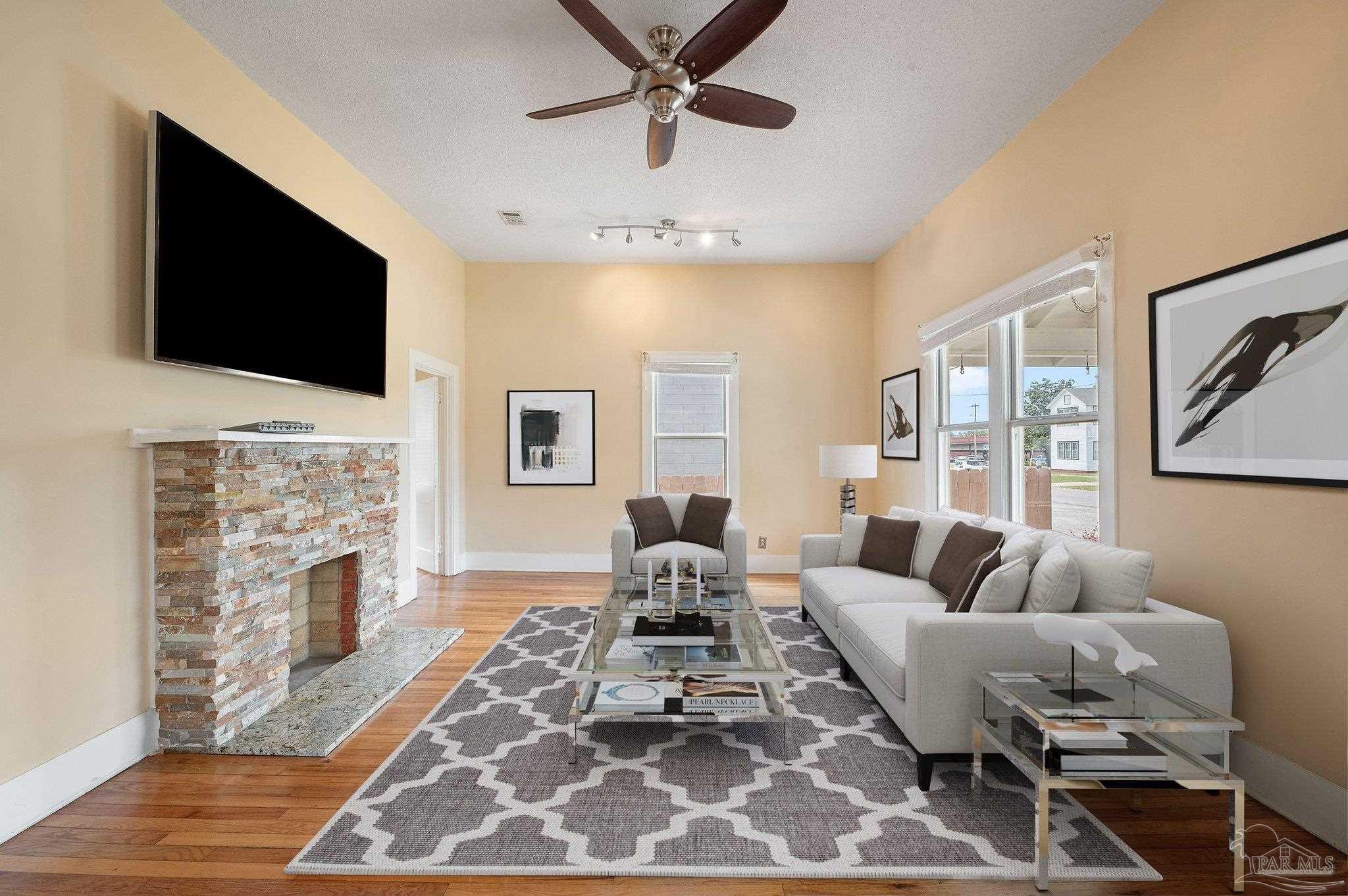 a living room with fireplace furniture and a flat screen tv