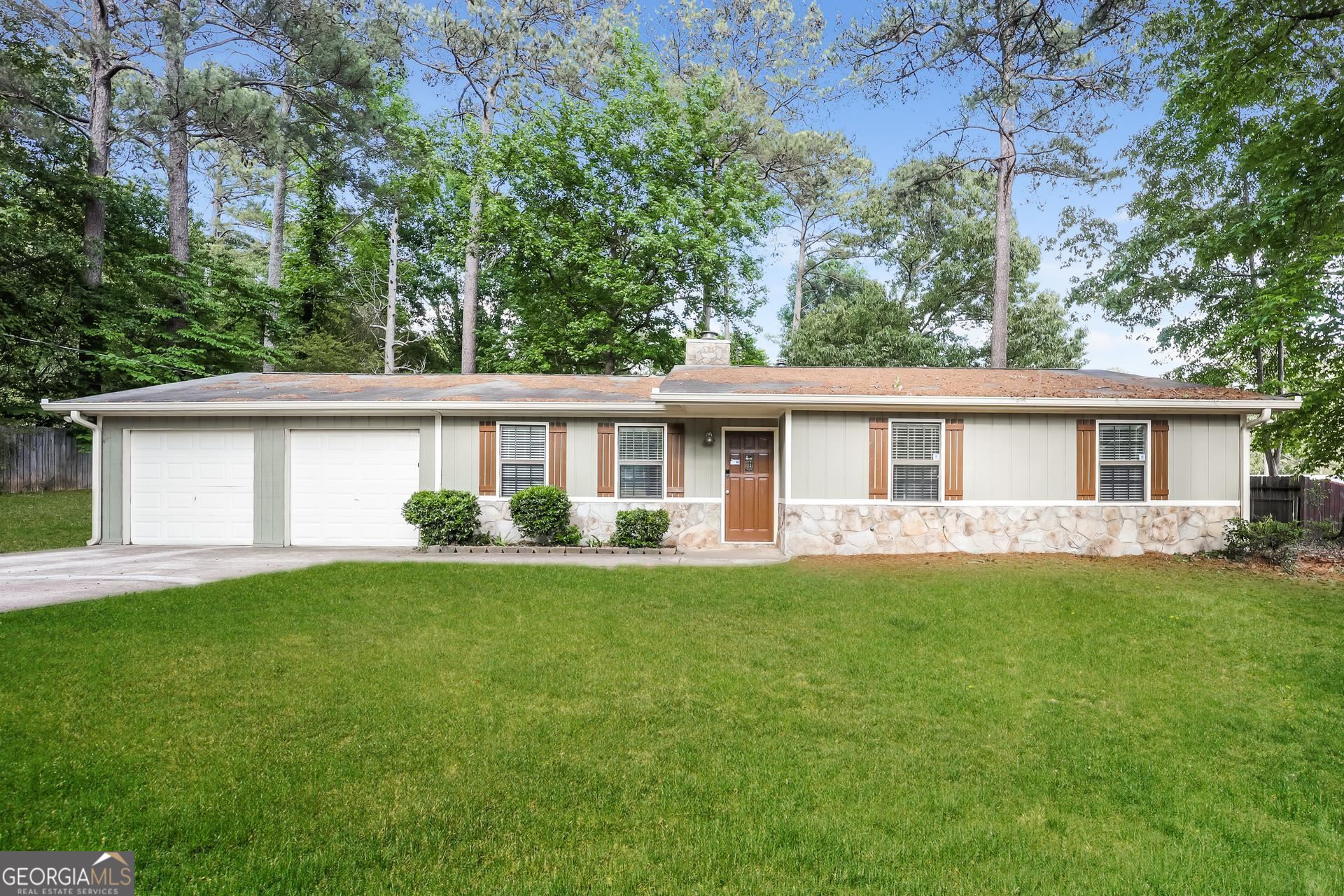 front view of a house with a garden