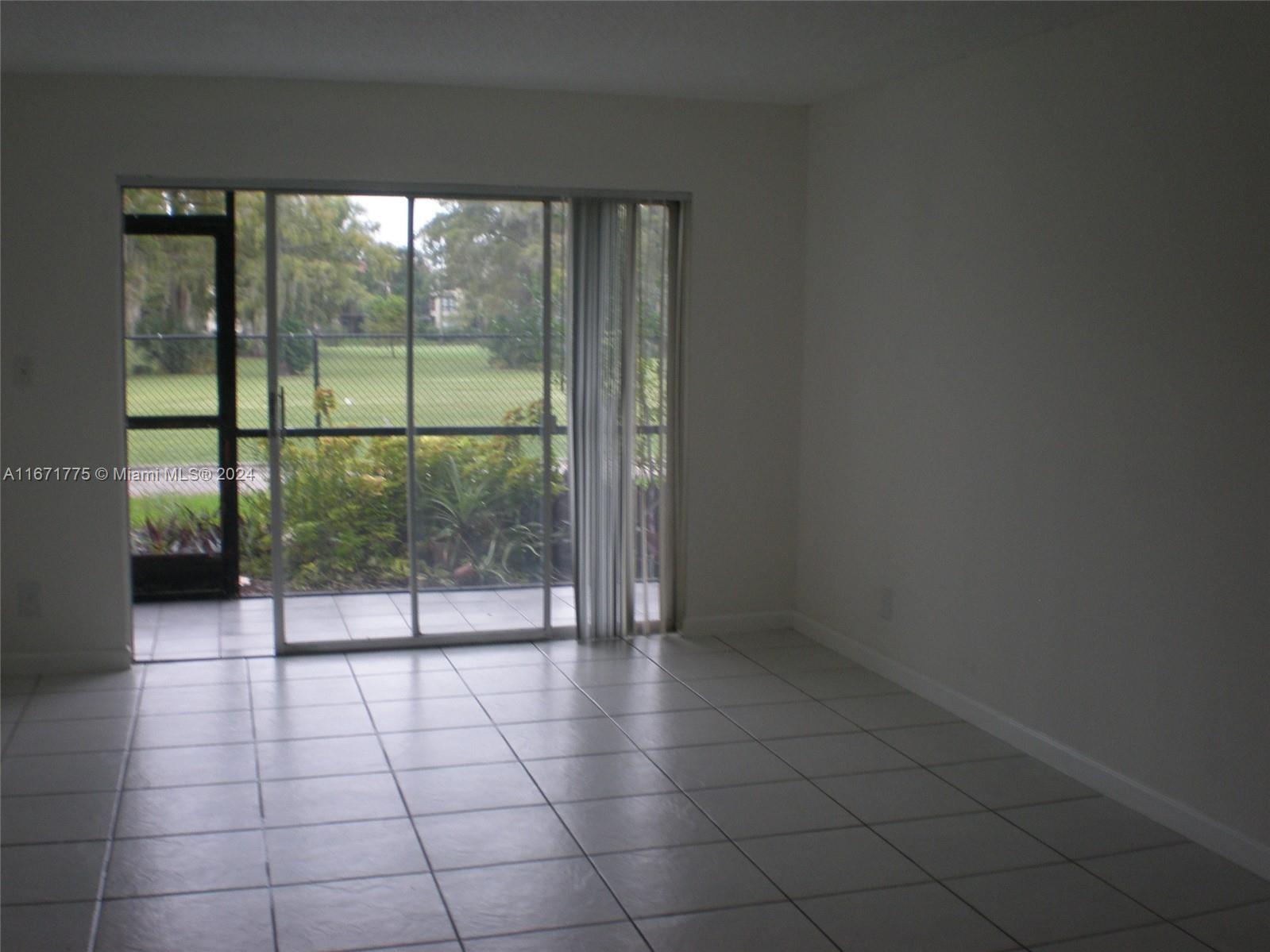 an empty room with sliding glass door