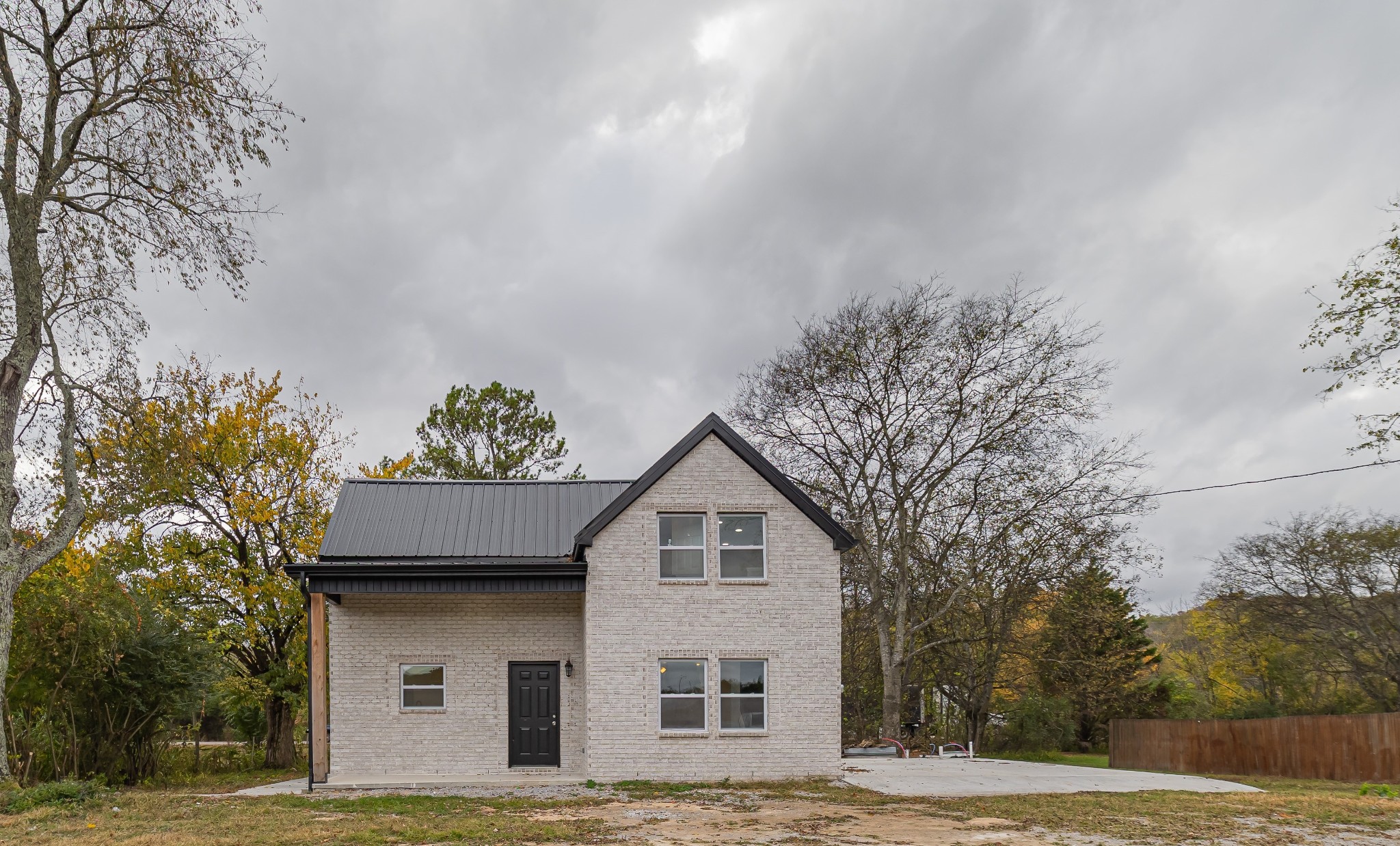 a house that has a tree in front of it