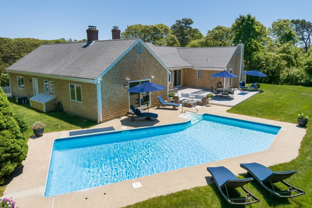 a view of a house with pool porch and chairs