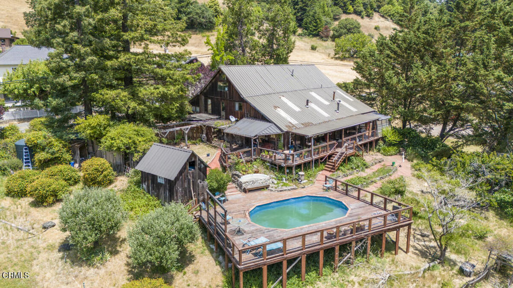 an aerial view of a house with a big yard and potted plants