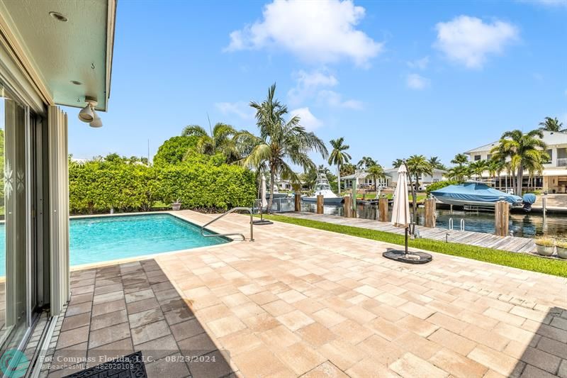 a view of a swimming pool with an outdoor space and seating area