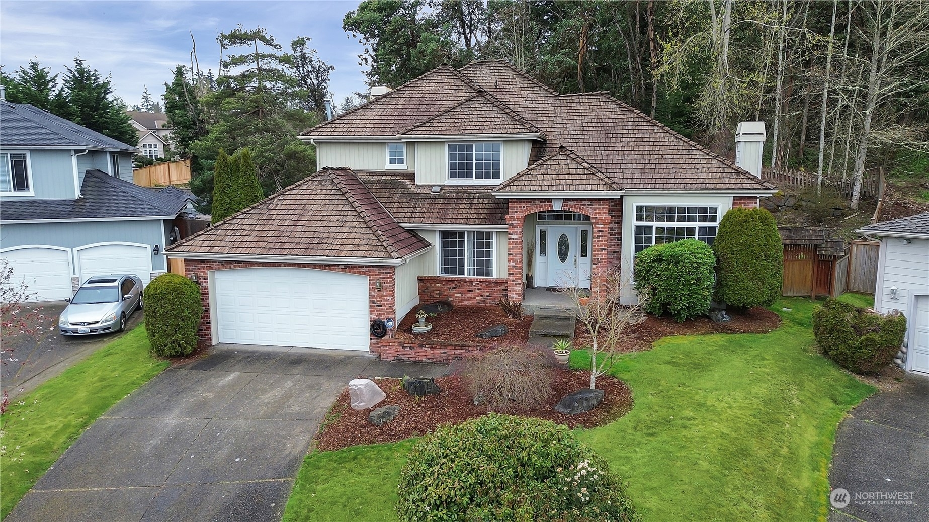 a view of a house with a yard and a garden