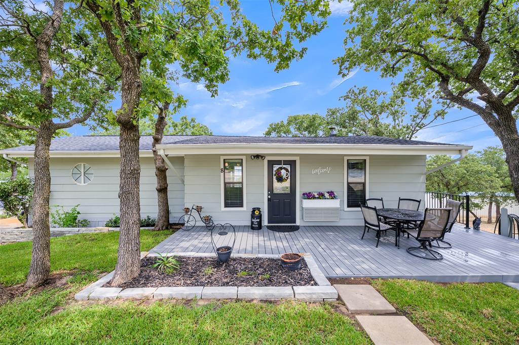 a view of a house with backyard sitting area and garden