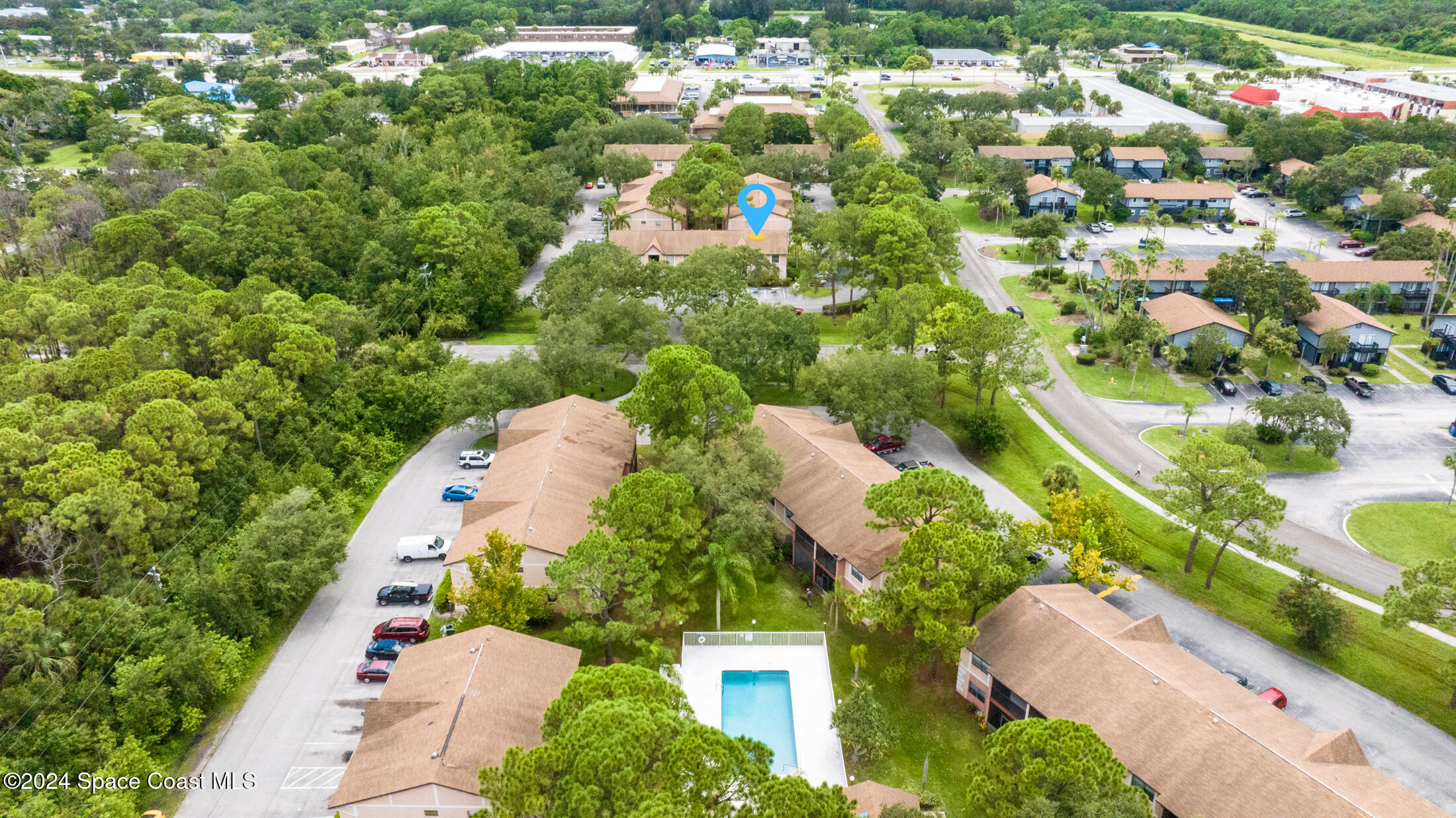 an aerial view of a house with a yard and lake view