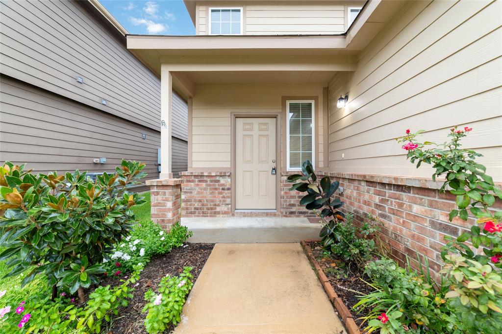 a front view of a house with a garden