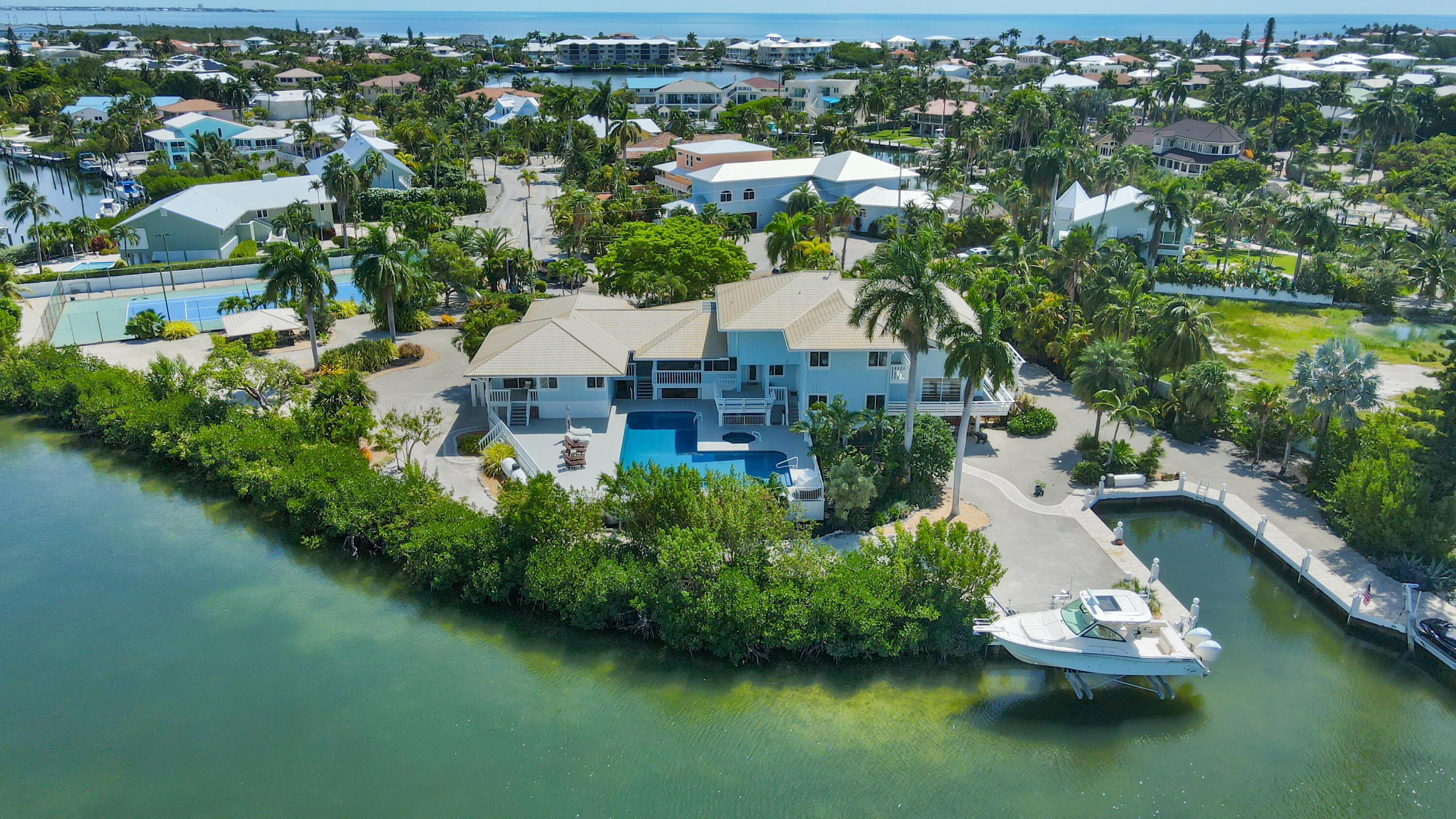 an aerial view of a house with a garden and lake view