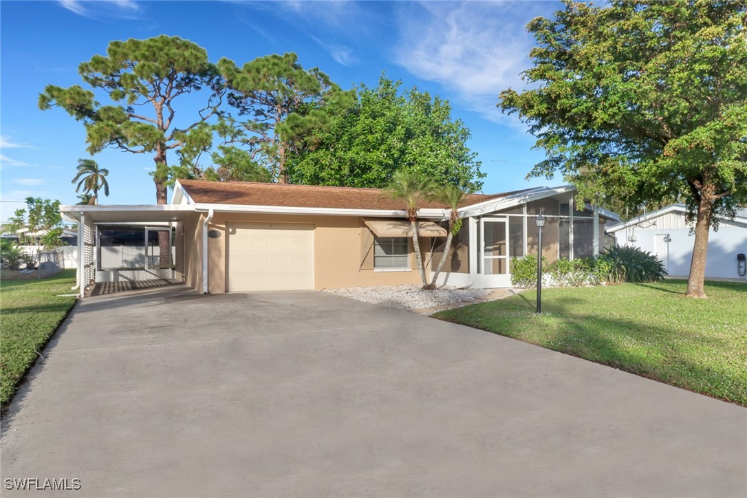 a view of house with outdoor space and garden