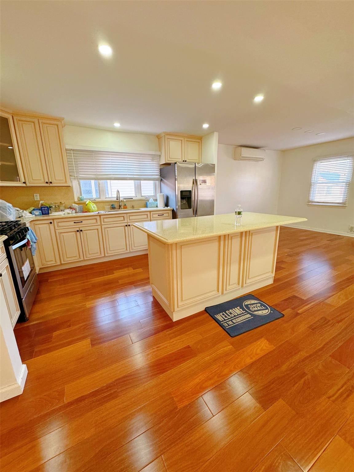 Kitchen with a center island, stainless steel appliances, and light hardwood / wood-style flooring