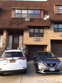 a front view of a house with parking space