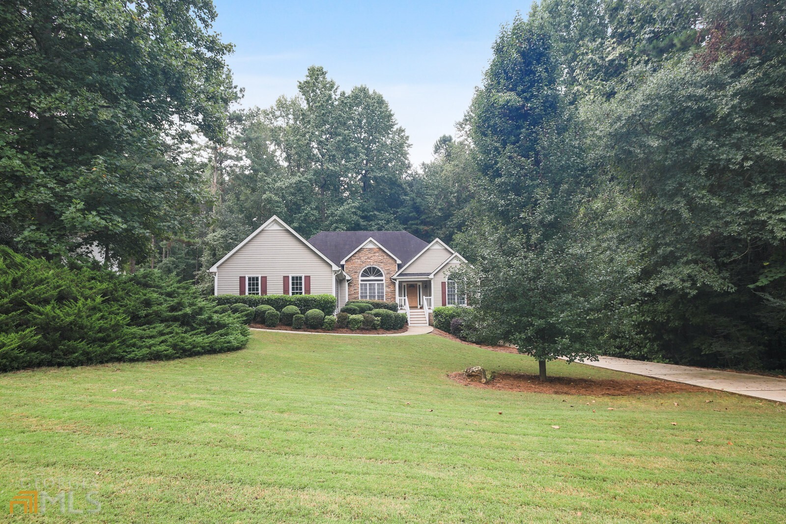 a view of a large house with a big yard and large tree